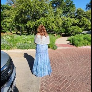 A baby blue mermaid fit cross back prom dress, worn only once.